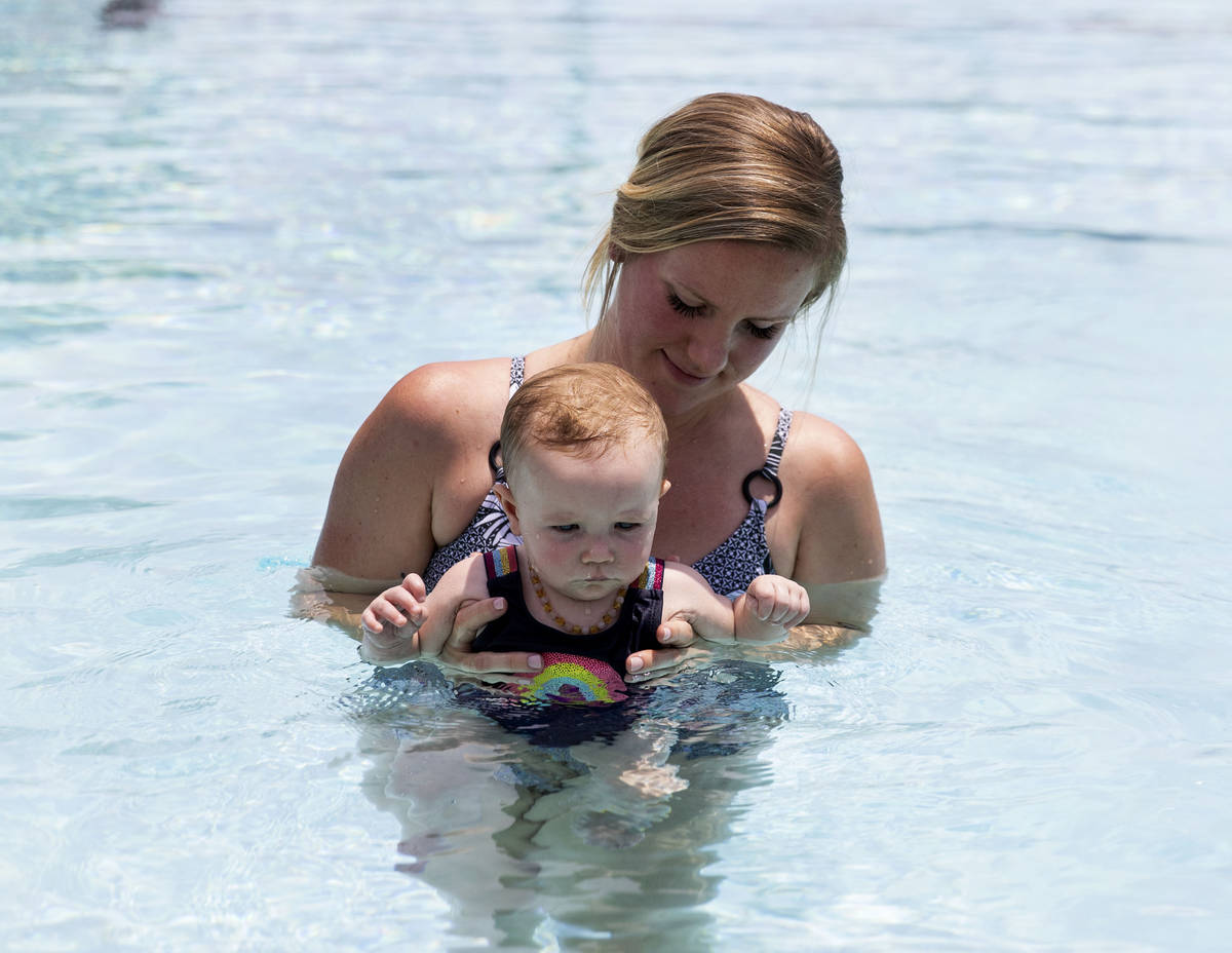 Taylor Speight gives swimming lesson to her seven-month-old daughter Stevie at Boulder City Swi ...
