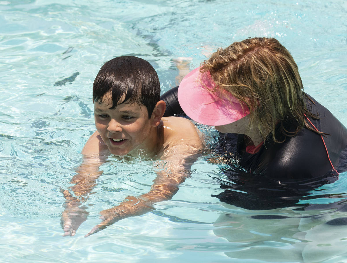 Kim Tyler, a volunteer instructor, helps Landyn Rowe, 10, during the 12th annual World's Larges ...