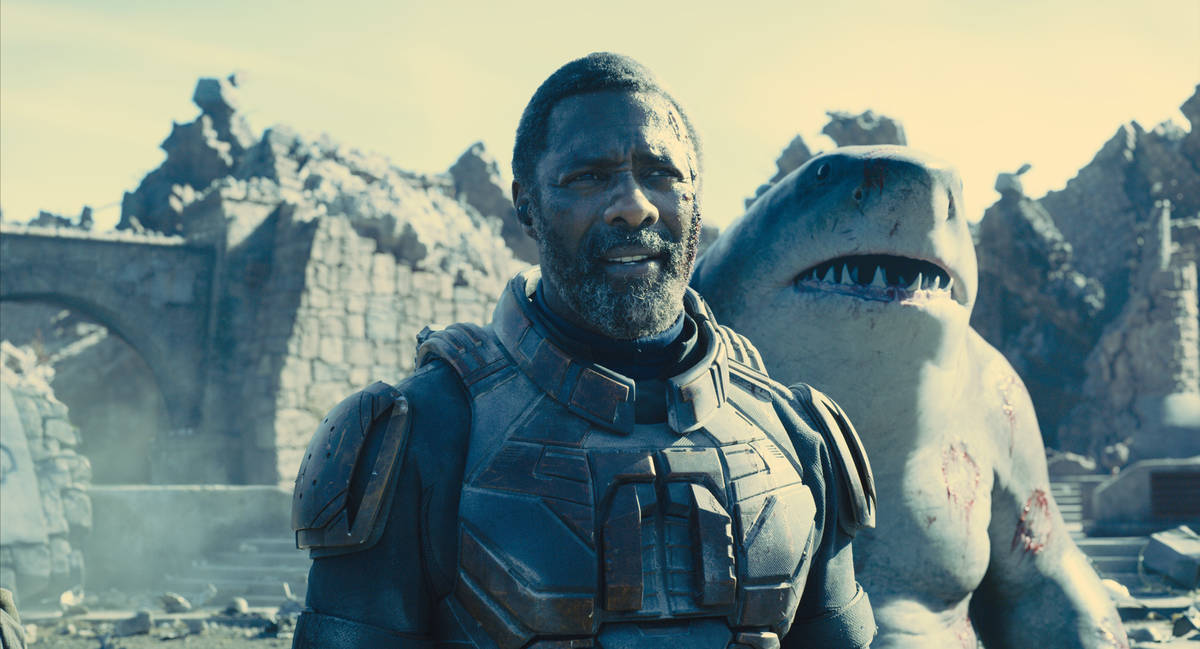 IDRIS ELBA as Bloodsport and KING SHARK appear in a scene from “THE SUICIDE SQUAD.” (Warne ...