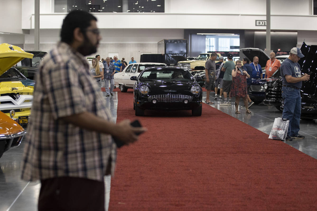 A 2002 Ford Thunderbird convertible is driven in the showroom floor of the Barrett-Jackson auct ...