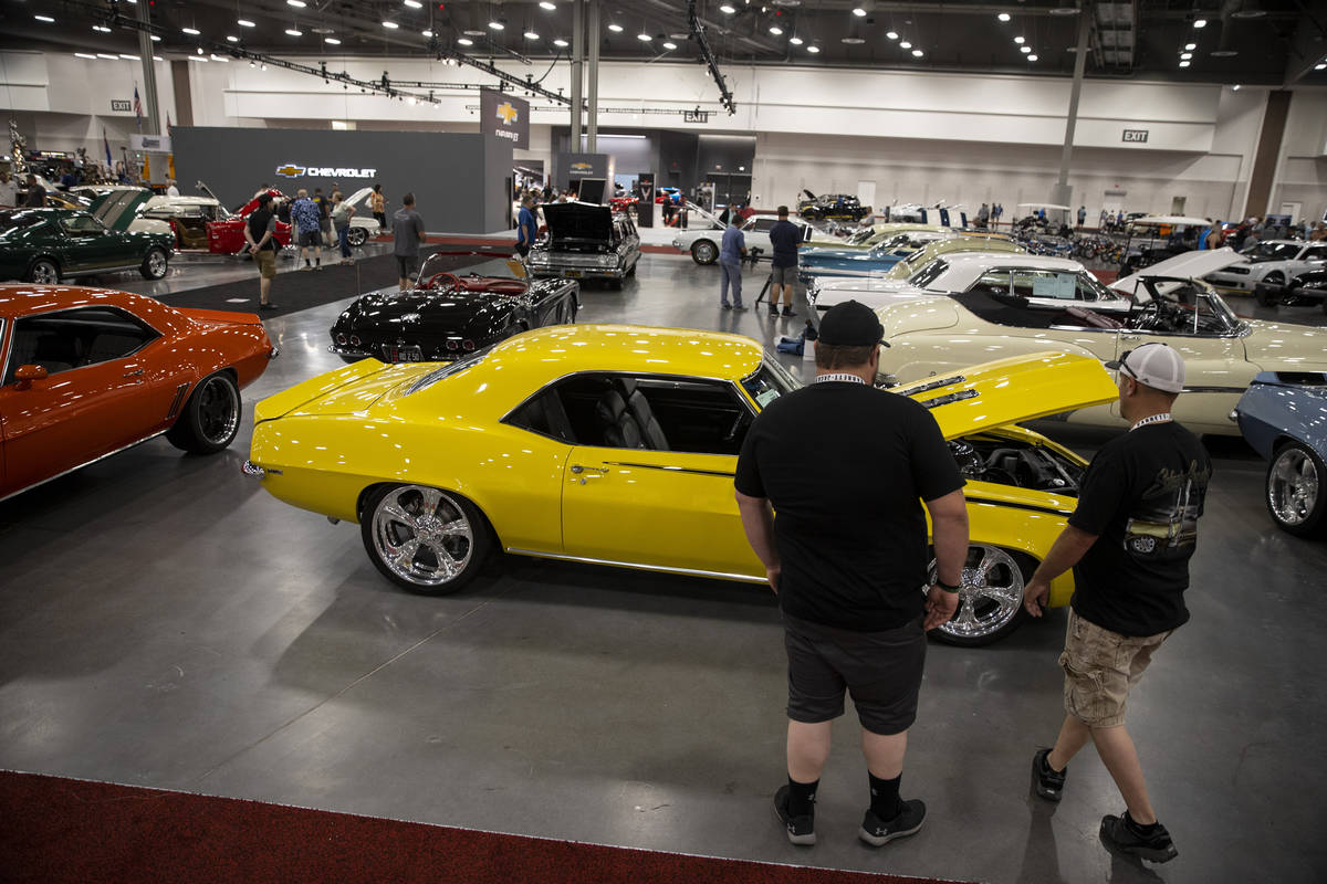 People check out cars showcased in the Barrett-Jackson auction at the Las Vegas Convention Cent ...