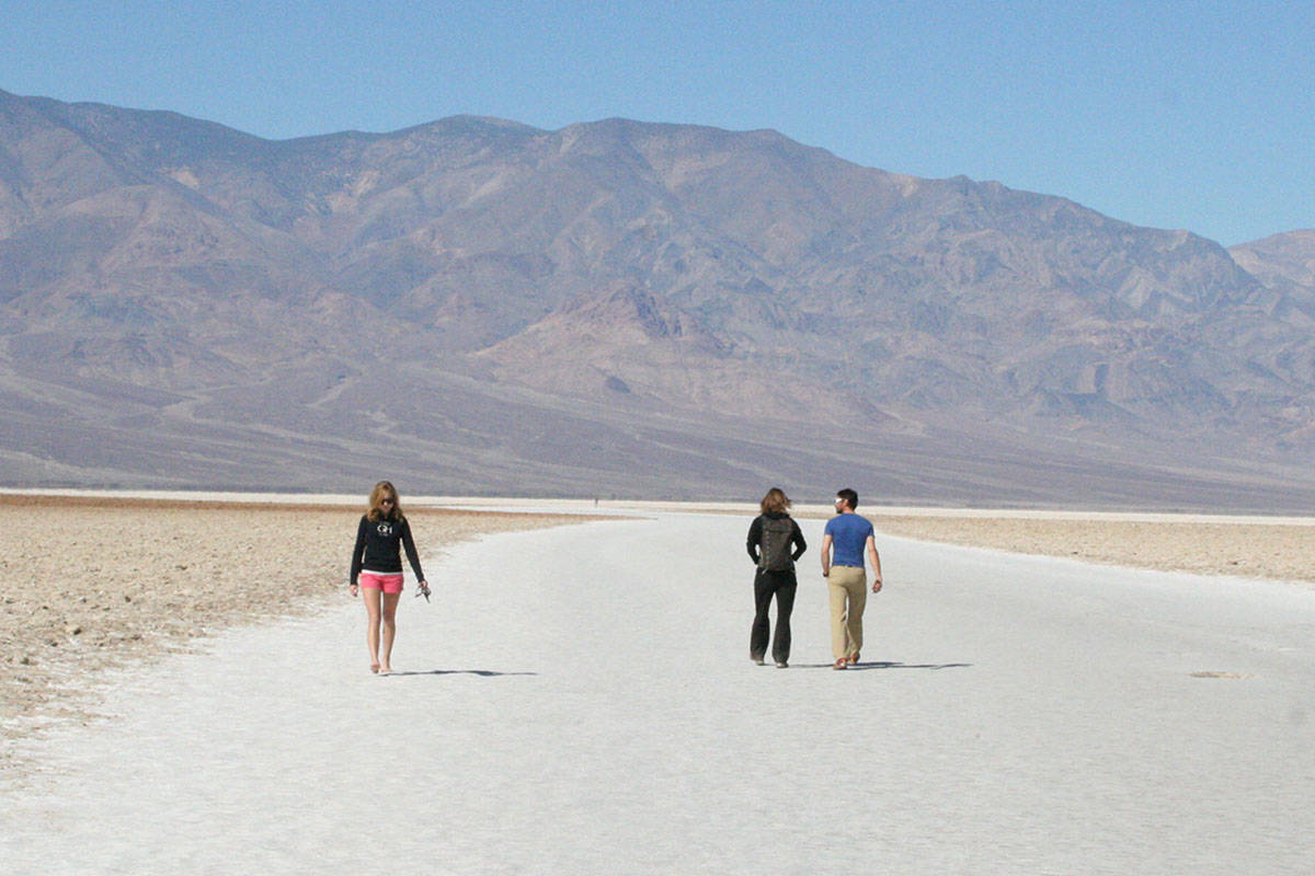 Visitors walk the salt flats at Badwater Basin in Death Valley National Park in California. (La ...