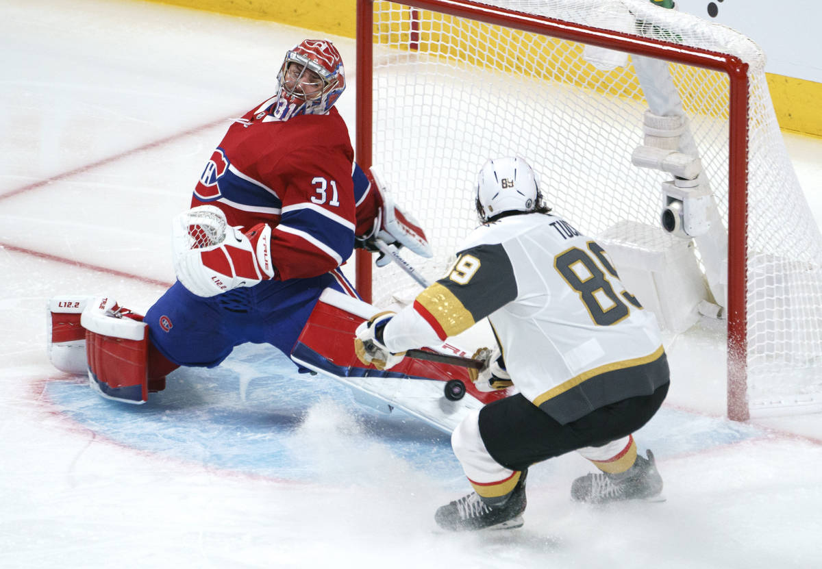 Montreal Canadiens goaltender Carey Price makes a save on Vegas Golden Knights' Alex Tuch durin ...