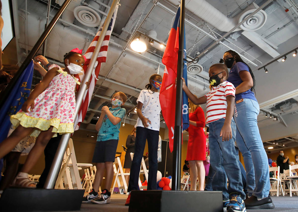 Jacobi Holmes, 4 of Las Vegas, right, touches a Juneteenth flag with other children before a Ju ...