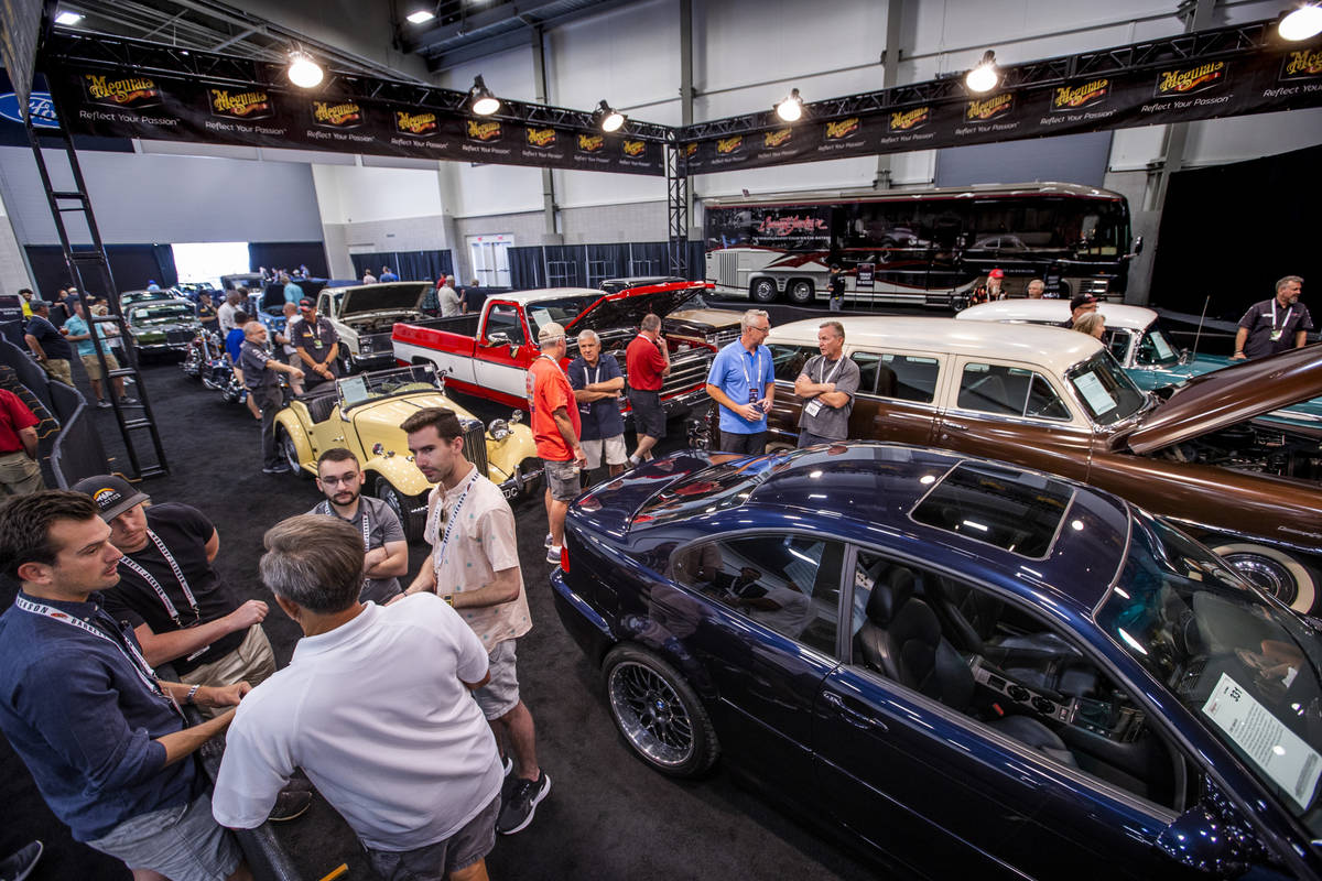 Invited guests gather in the cue area as cars up for bid will soon be sold during the Barrett-J ...