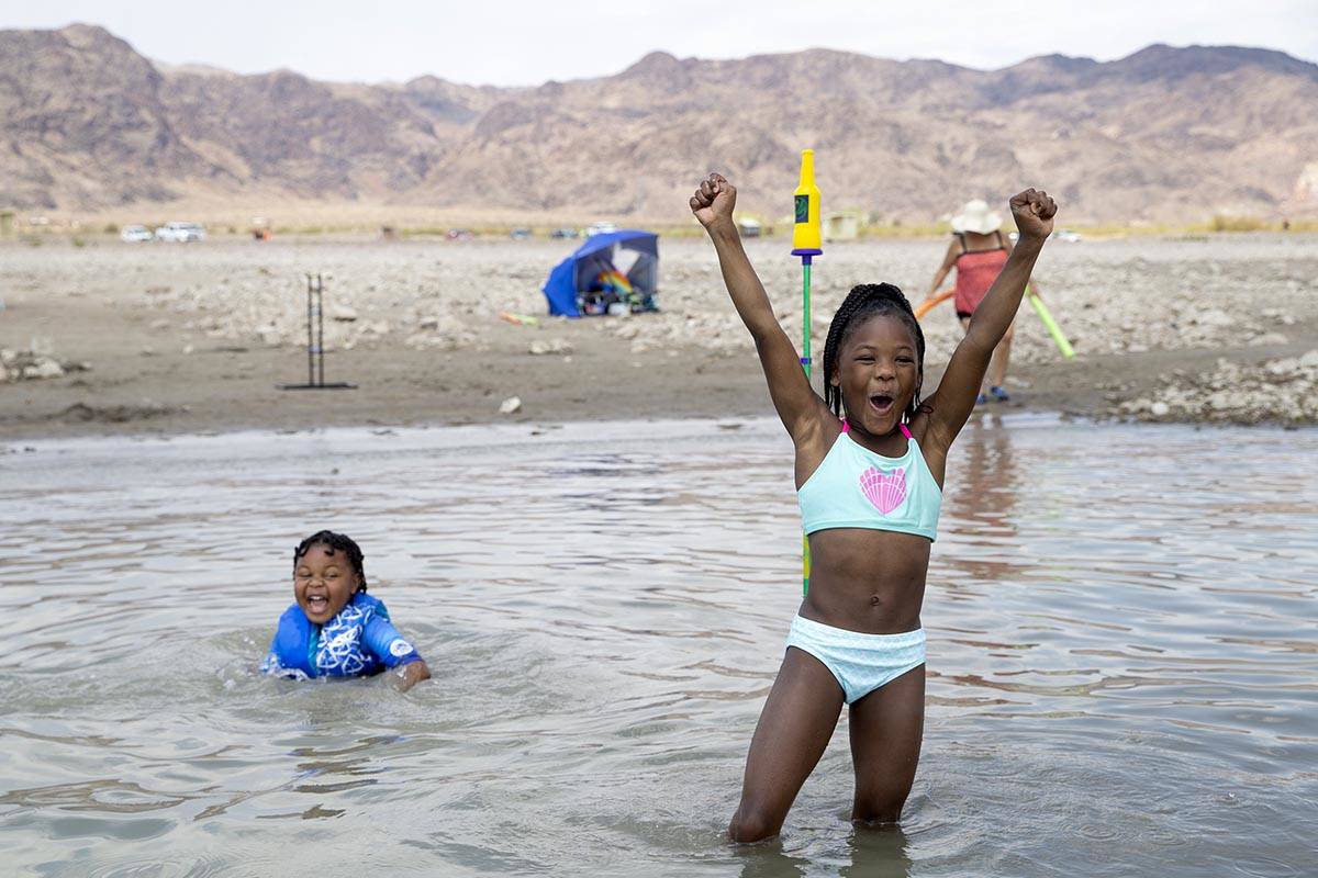 Jaden Richardson, 6, left, and Jaki Walker, 8, both of North Las Vegas, cheer as Walker made he ...