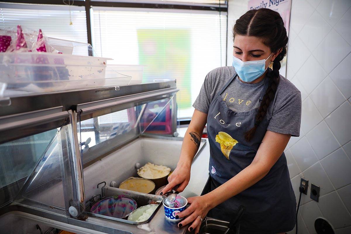 Gabrielle Holloway scoops ice cream for a customer at her family’s Baskin Robbins in Hen ...