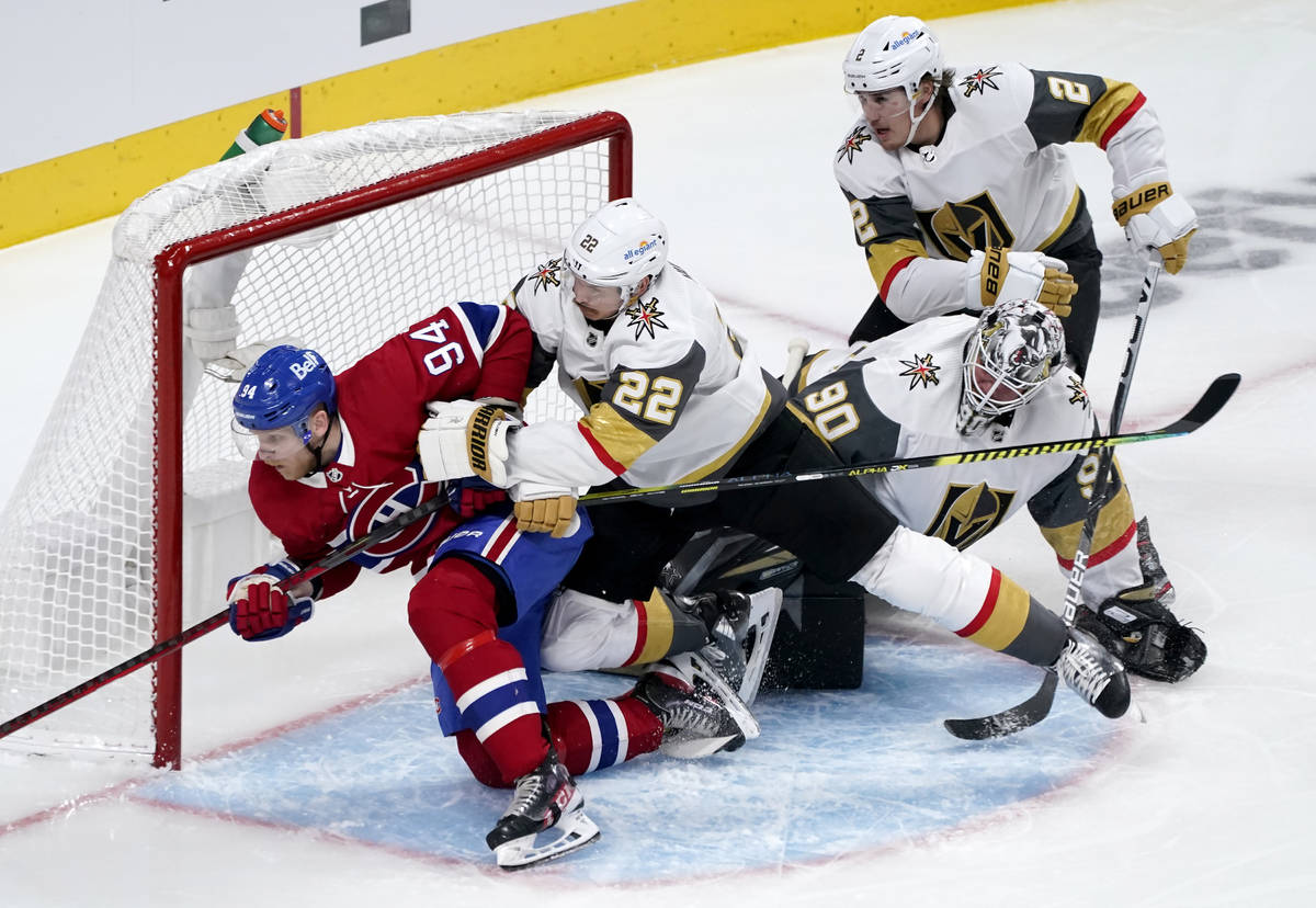 Vegas Golden Knights' Nick Holden (22) tries to clear Montreal Canadiens' Corey Perry (94) from ...