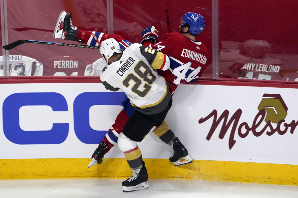 Vegas Golden Knights' William Carrier (28) checks Montreal Canadiens' Joel Edmundson (44) durin ...