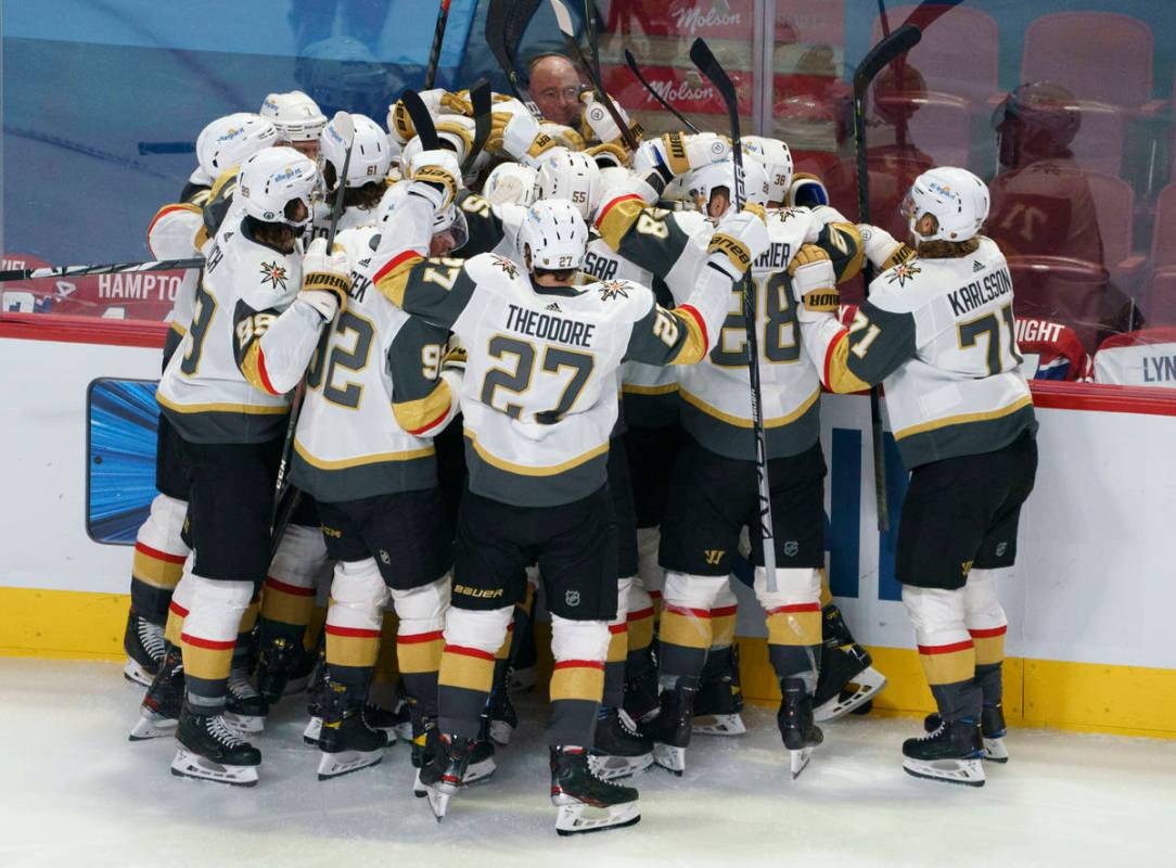 Members of the Vegas Golden Knights gather around teammate Nicolas Roy after scoring the winnin ...