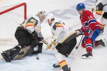 Montreal Canadiens' Nick Suzuki (14) moves in on Vegas Golden Knights goaltender Robin Lehner a ...