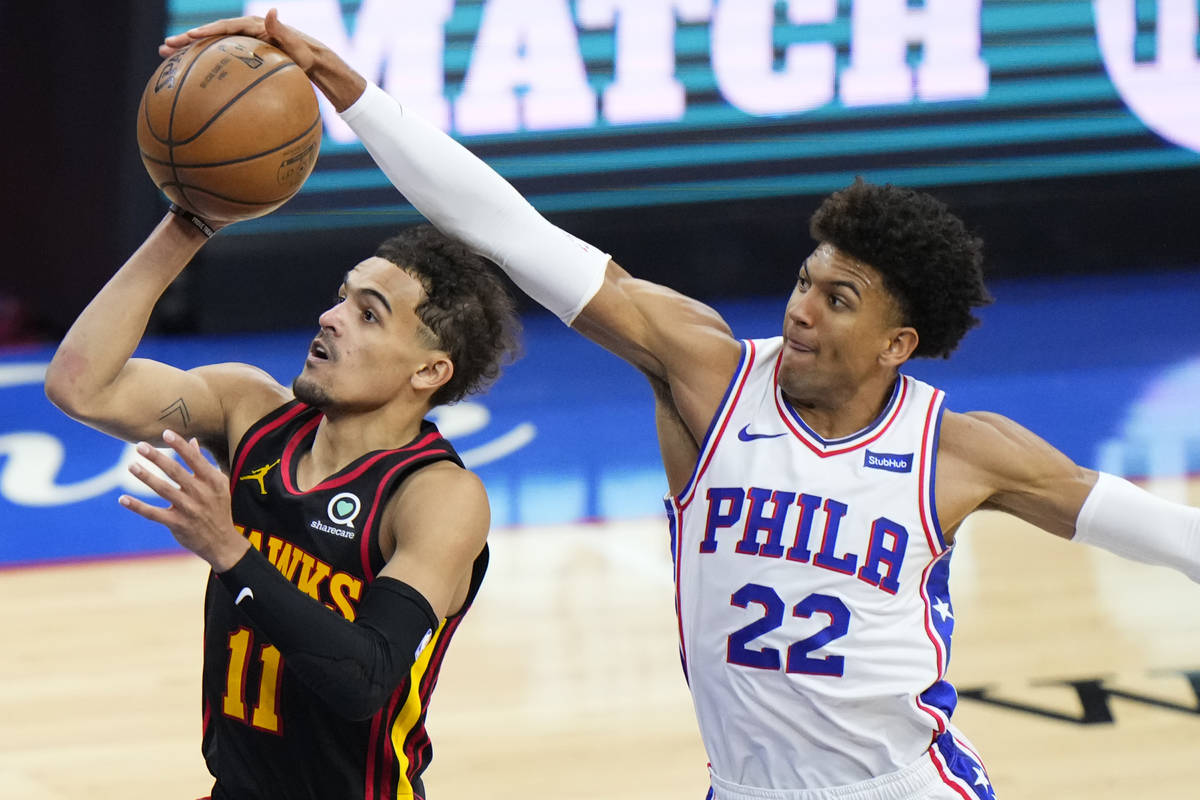 Philadelphia 76ers' Matisse Thybulle, right, blocks a shot by Atlanta Hawks' Trae Young during ...
