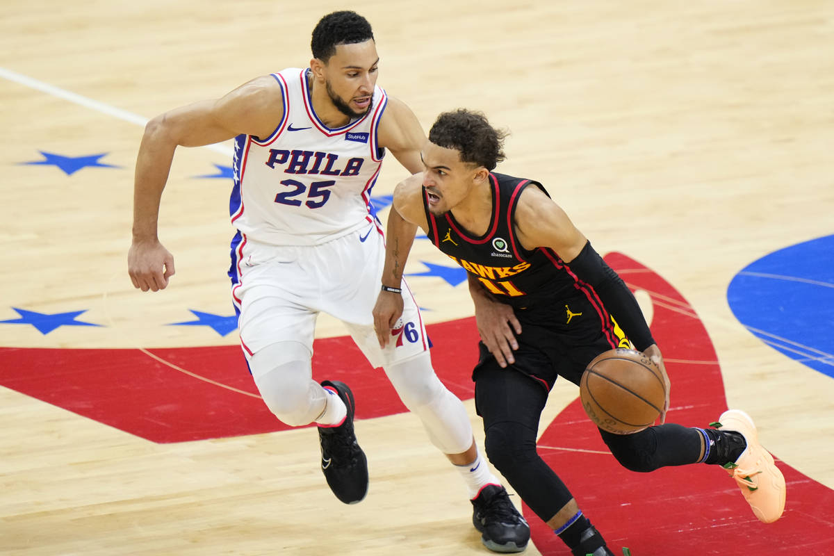 Atlanta Hawks' Trae Young, right, tries to get past Philadelphia 76ers' Ben Simmons during the ...