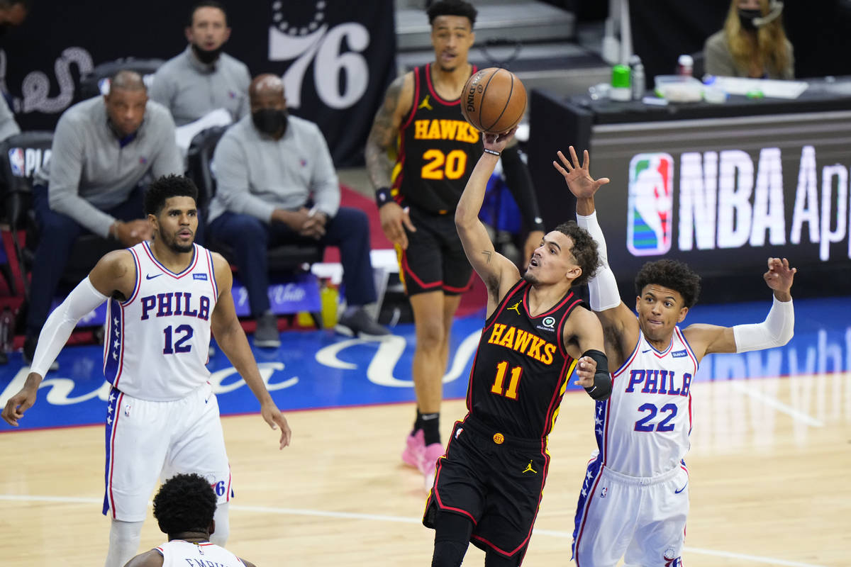 Atlanta Hawks' Trae Young (11) goes up for a shot against Philadelphia 76ers' Matisse Thybulle ...