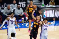 Atlanta Hawks' Trae Young (11) goes up for a shot against Philadelphia 76ers' Matisse Thybulle ...