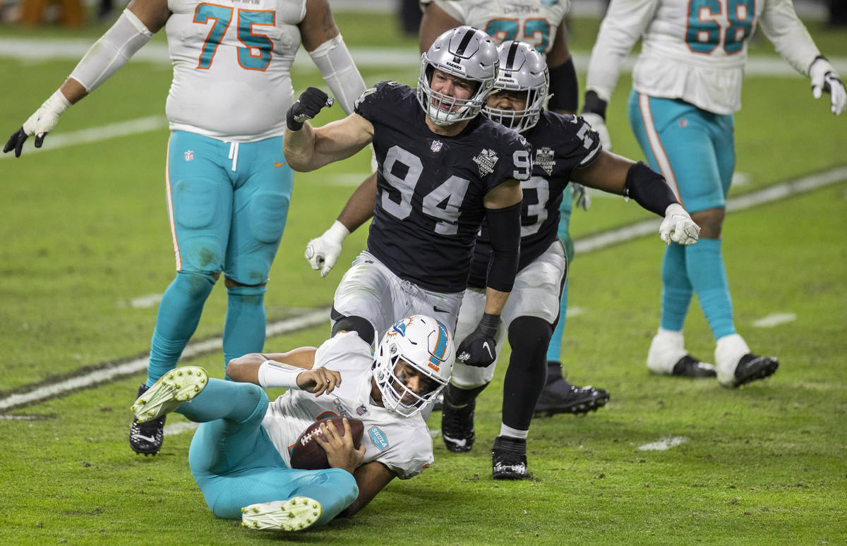 Raiders defensive end Carl Nassib (94) sacks Miami Dolphins quarterback Tua Tagovailoa (1) in t ...