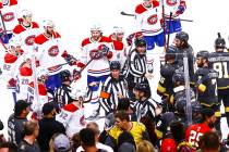 Referees try to keep the Montreal Canadiens from the Golden Knights after the Habs defeated the ...