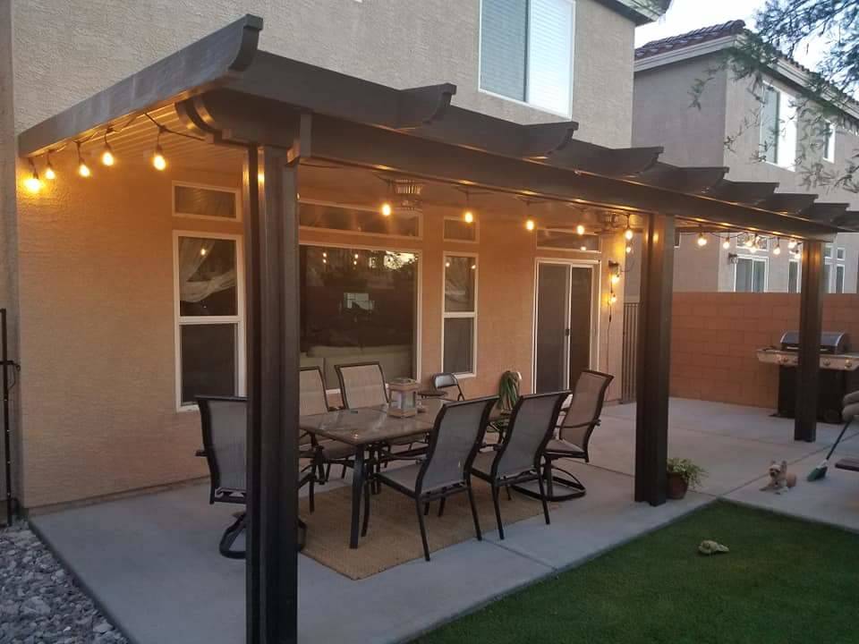 Lights on the patio cover add a festive look to the outdoor dining area. (Custom Outdoor Creations)