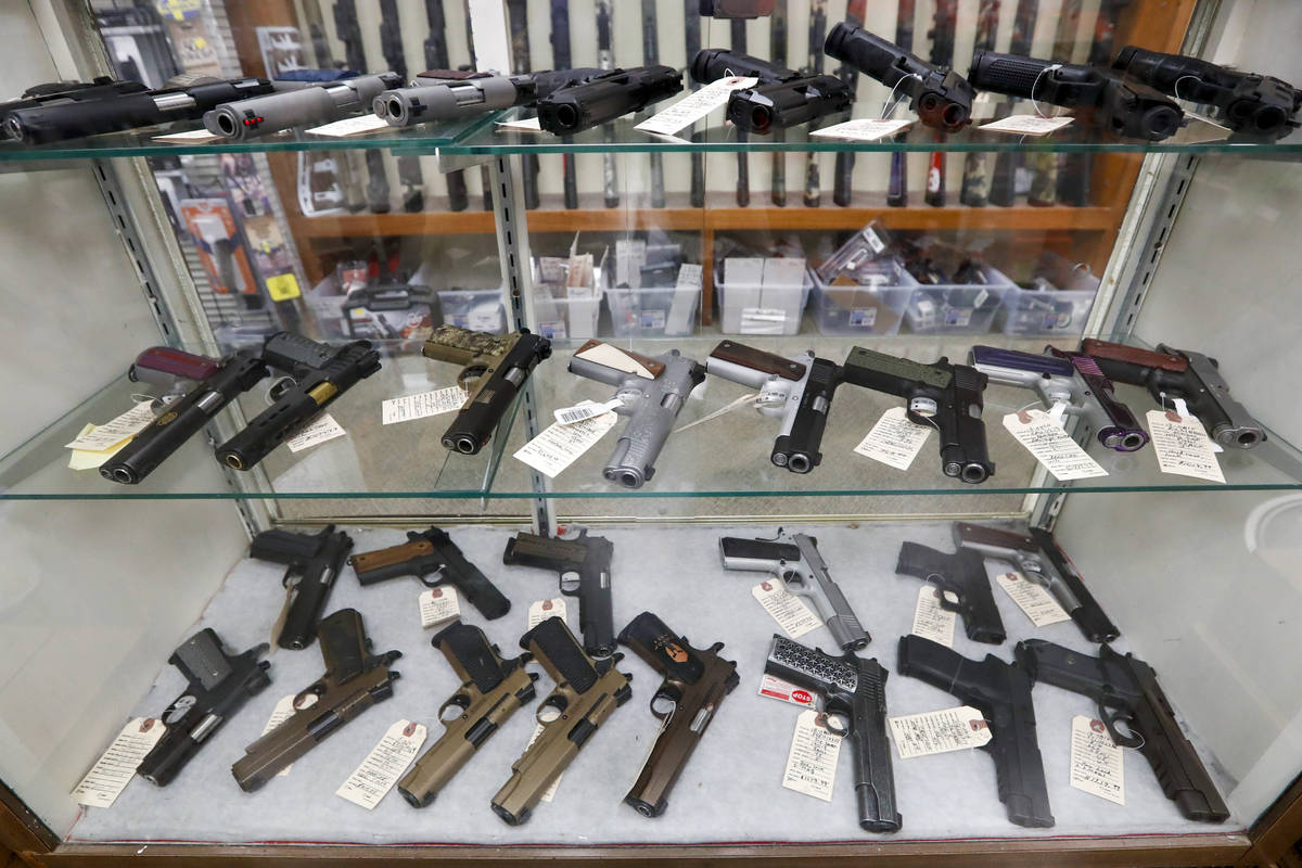 FILE - In this March 25, 2020, file photo semi-automatic handguns are displayed at shop in New ...
