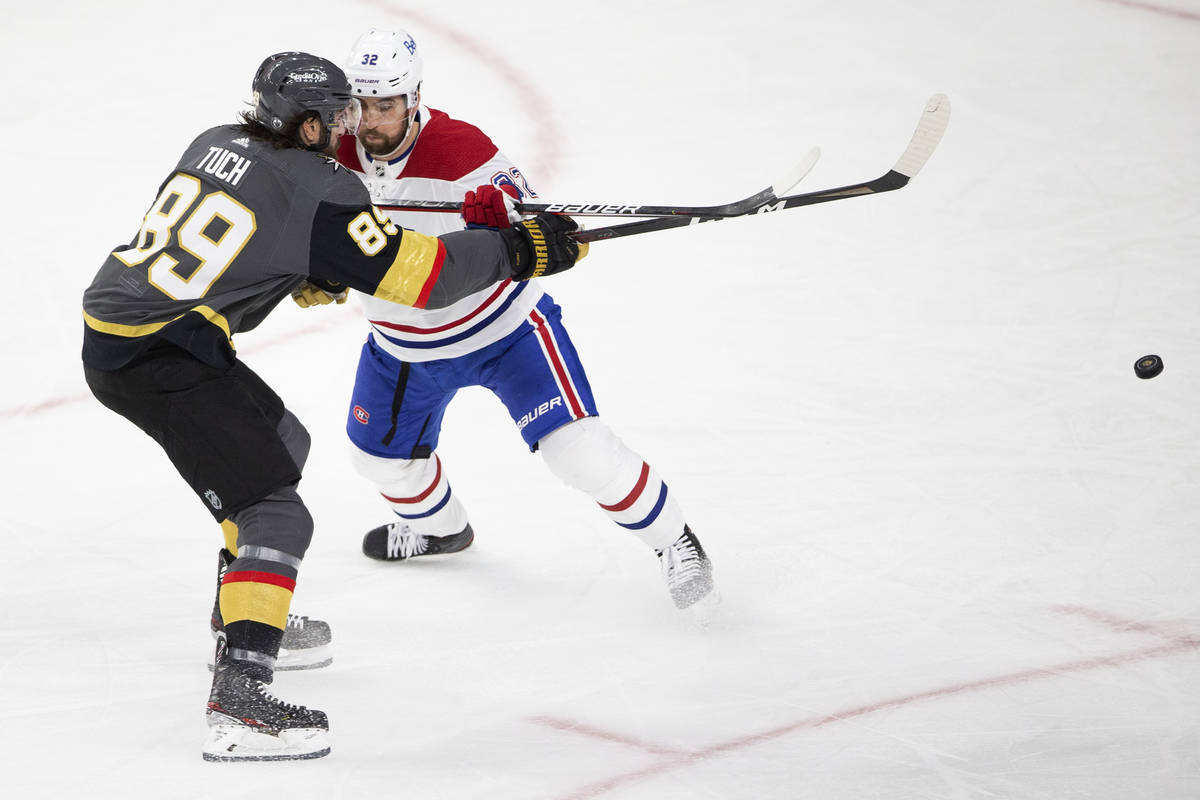 Golden Knights right wing Alex Tuch (89) takes a shot on goal while Canadiens defenseman Erik G ...