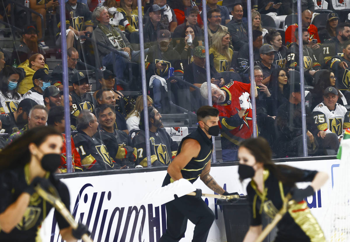 A Golden Knights fan wipes down the glass during a break in the first period of Game 5 of an NH ...