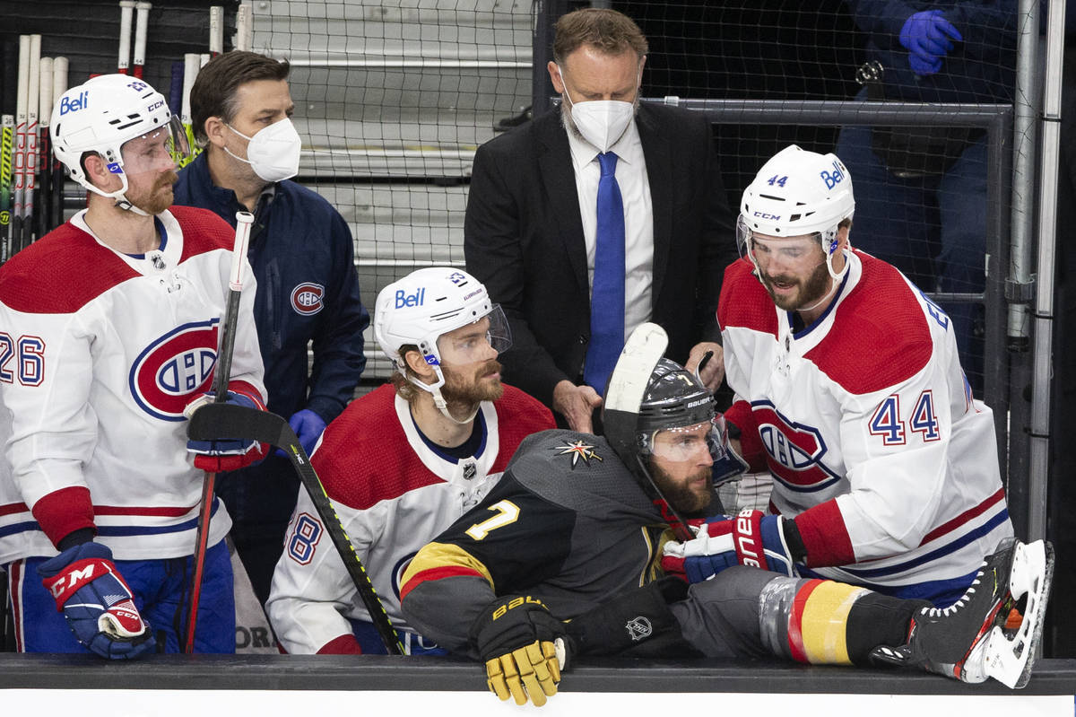 Golden Knights defenseman Alex Pietrangelo (7) falls into the Canadiens' bench while Canadiens ...