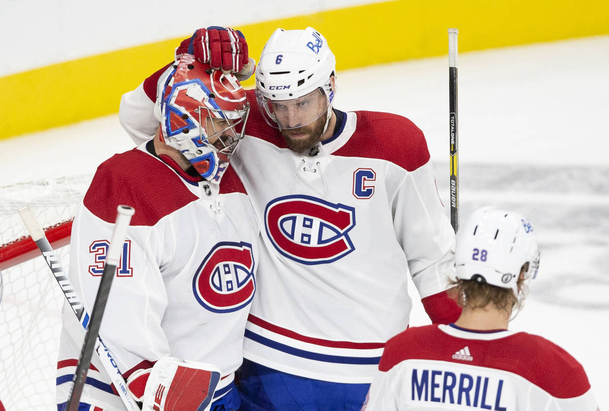 Canadiens goaltender Carey Price (31) is congratulated by Canadiens defenseman Shea Weber (6) a ...