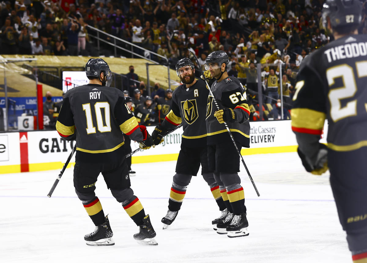 Golden Knights' Max Pacioretty (67) celebrates his goal with Nicolas Roy (10) and Alex Pietrang ...