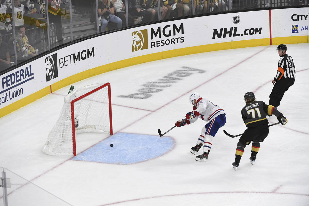 Montreal Canadiens center Nick Suzuki (14) shoots an empty net goal ahead of Vegas Golden Knigh ...