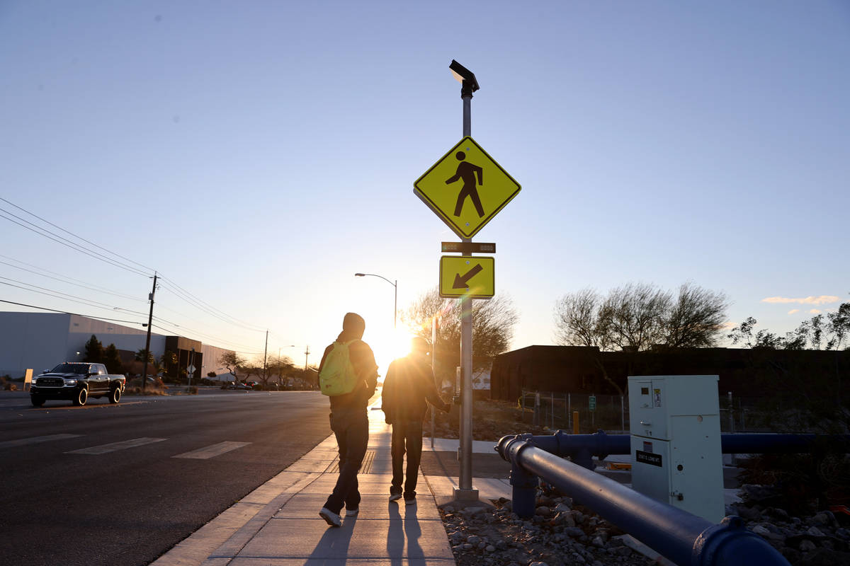 People use a crosswalk on Lone Mountain Road near Losee Road in North Las Vegas Wednesday, Marc ...