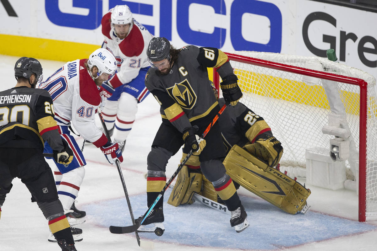 Golden Knights right wing Mark Stone (61) defends goaltender Marc-Andre Fleury (29) while Canad ...