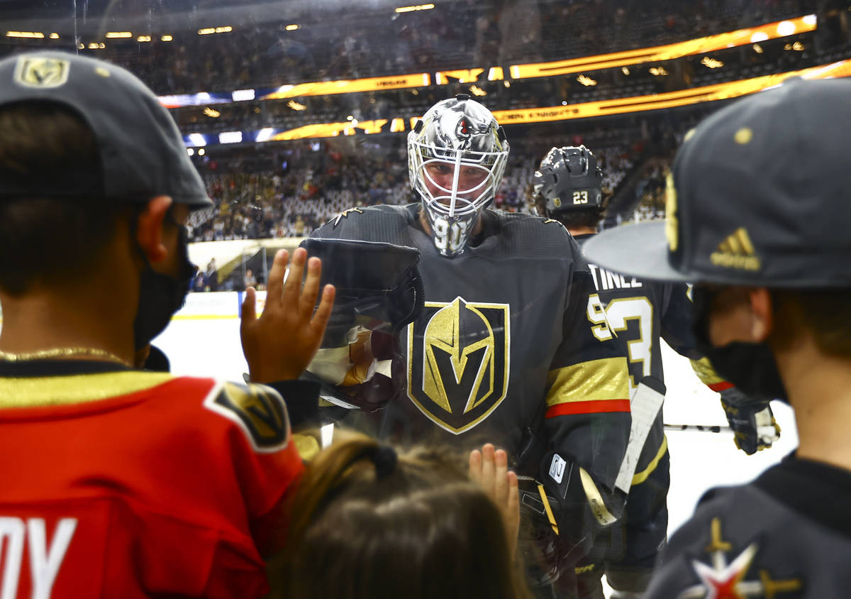 Golden Knights goaltender Robin Lehner (90) greets his kids Lennox, left, and Zoe before the st ...