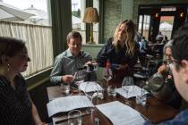 Caroline Styne, owner and wine director at The Lucques Group, serves wine to attorney Alec Nede ...