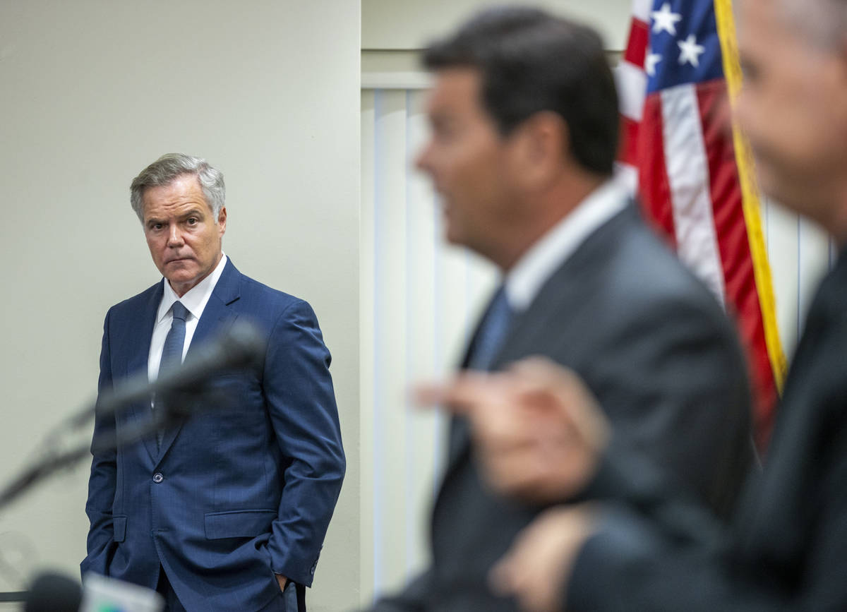 The Nevada COVID-19 Response, Relief and Recovery Task Force Chairman Jim Murren, left, looks o ...
