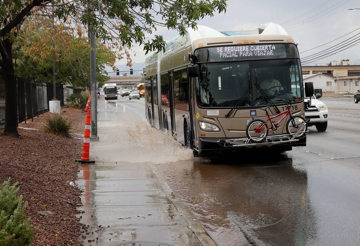 A Regional Transportation Commission bus drives through standing water after a light rain on Ch ...