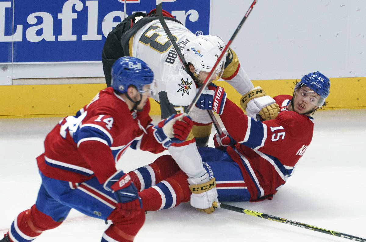 Montreal Canadiens' Jesperi Kotkaniemi (15) is dumped by Vegas Golden Knights' Peter DiLiberato ...