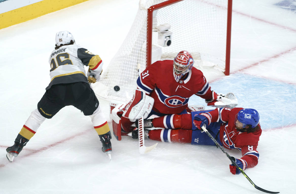 Montreal Canadiens' Ben Chiarot (8) slides into goaltender Carey Price as he makes a save off V ...