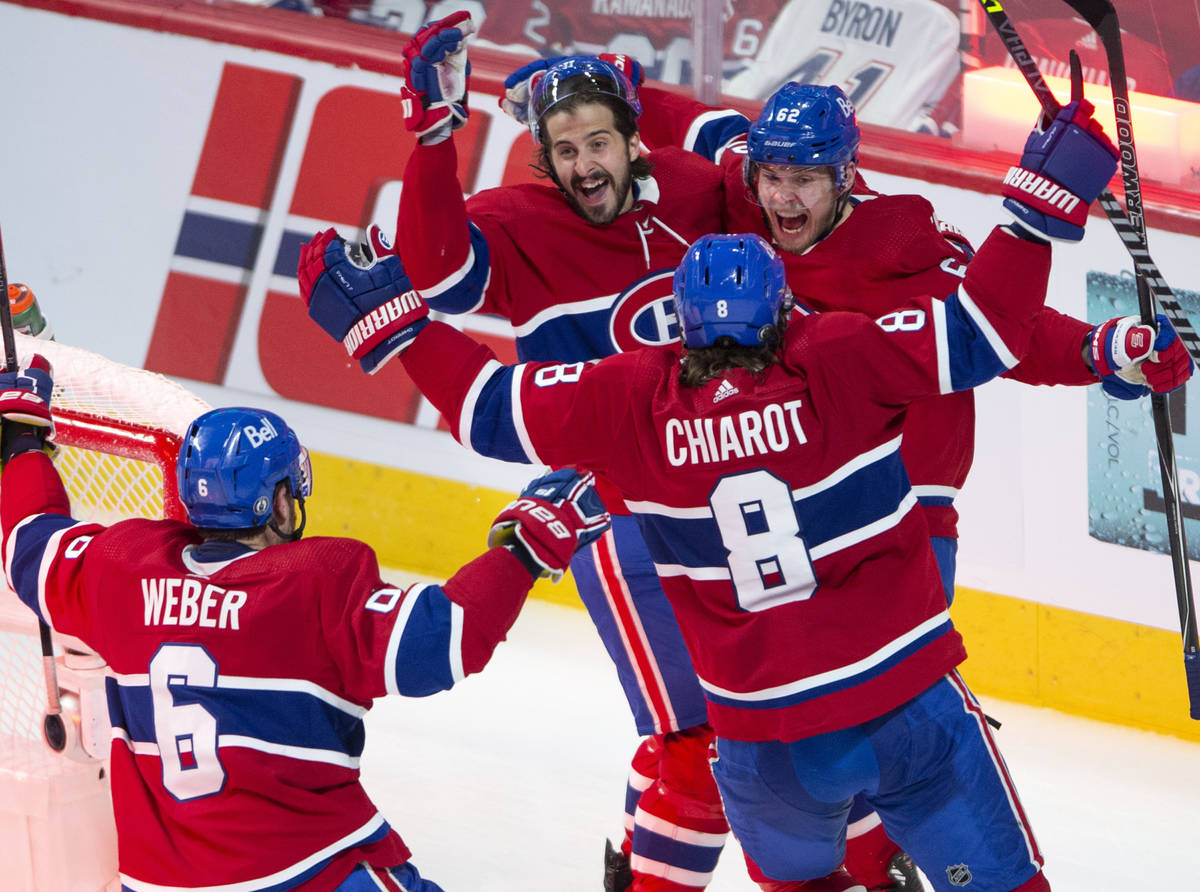 Montreal Canadiens left wing Artturi Lehkonen (62) celebrates with teammates after scoring the ...