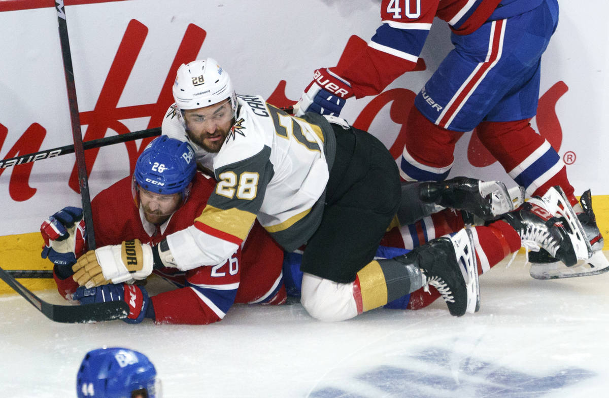 Vegas Golden Knights' William Carrier (28) falls on Montreal Canadiens' Jeff Petry (26) during ...