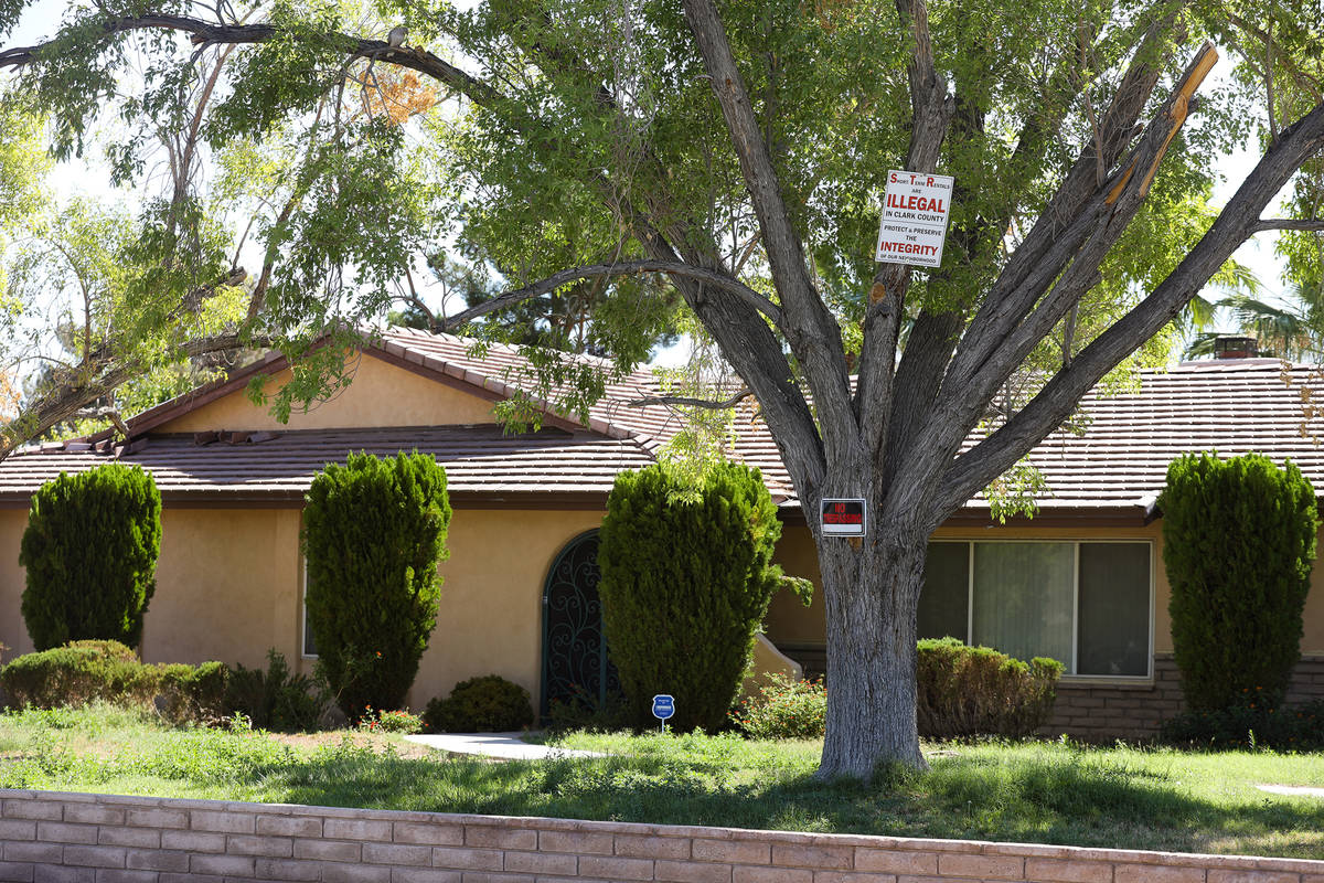 A sign against short-term rentals on a tree at a home in an unincorporated neighborhood in sout ...