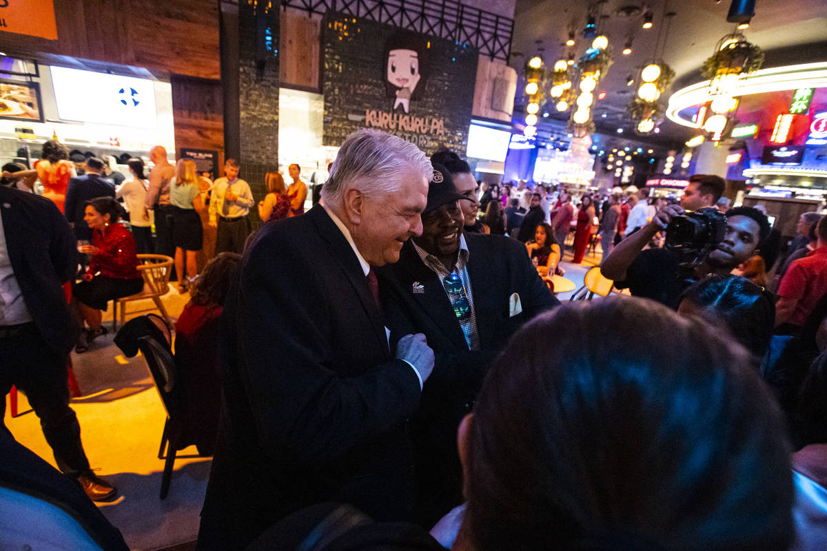 Gov. Steve Sisolak greets attendees during the opening night of Resorts World Las Vegas on Thur ...