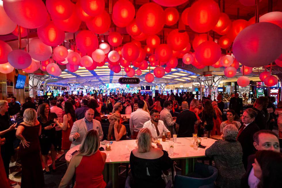 People drink and mingle at Gatsby's cocktail lounge during the opening night of Resorts World L ...