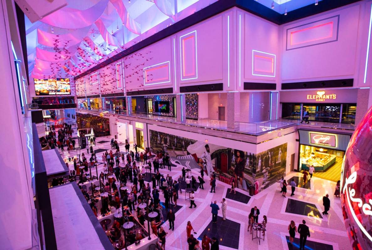 People walk around The District during the opening night of Resorts World Las Vegas on Thursday ...