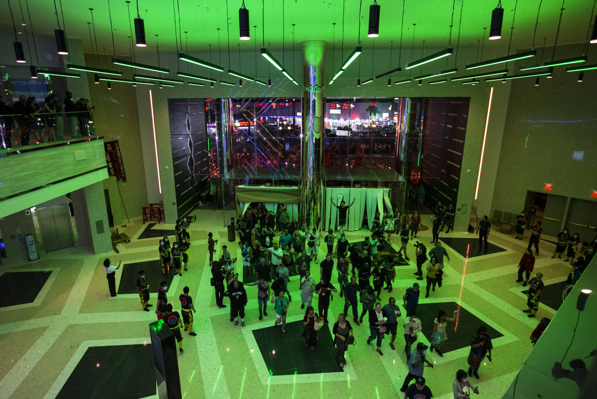 People walk into The District as the doors open to the public at Resorts World Las Vegas on Thu ...