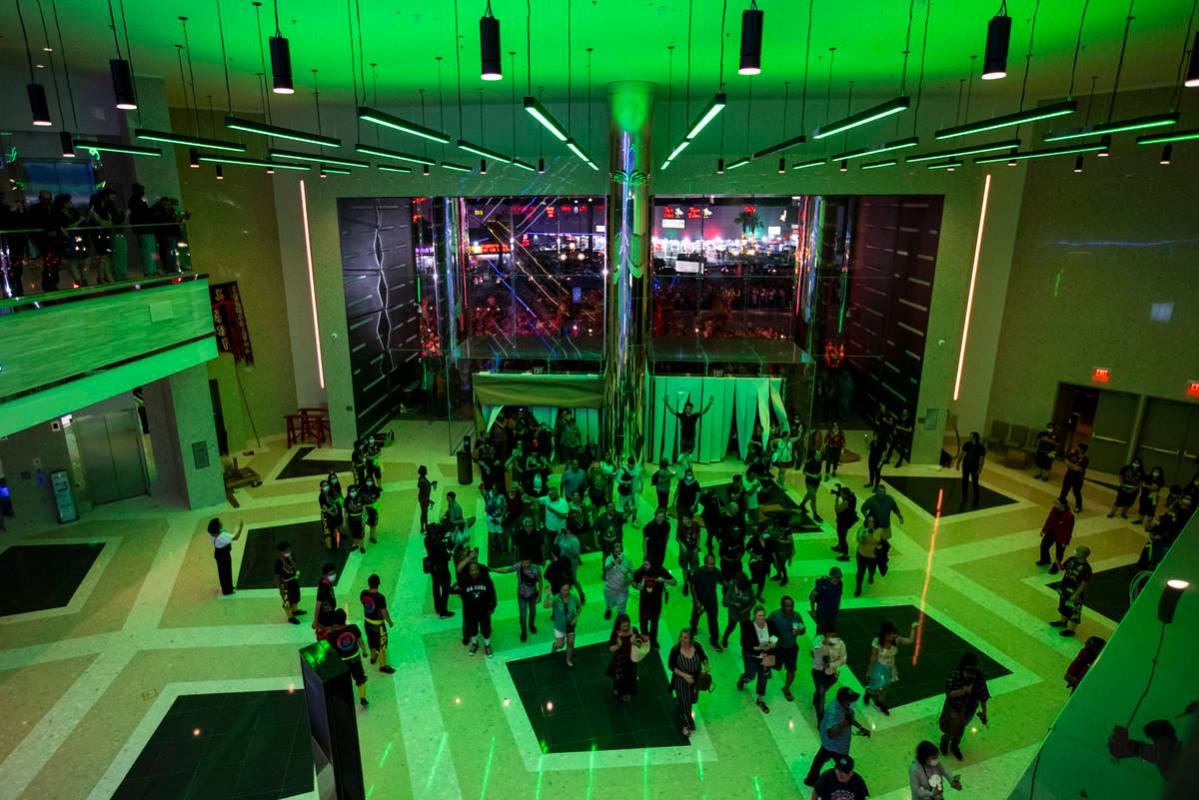 People walk into The District as the doors open to the public at Resorts World Las Vegas on Thu ...