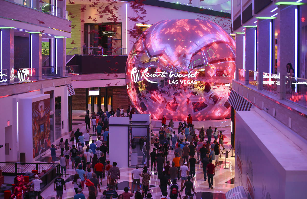 People walk into The District as the doors open to the public at Resorts World Las Vegas on Thu ...