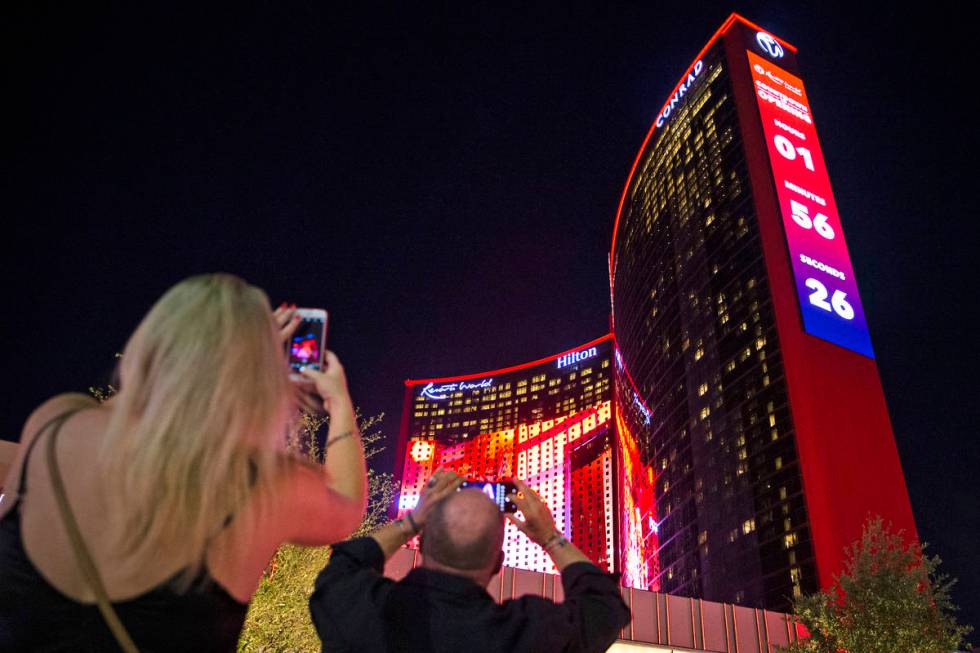 Beth Burdick, left, and Mark Gierth, both of Las Vegas, photograph Resorts World Las Vegas on T ...