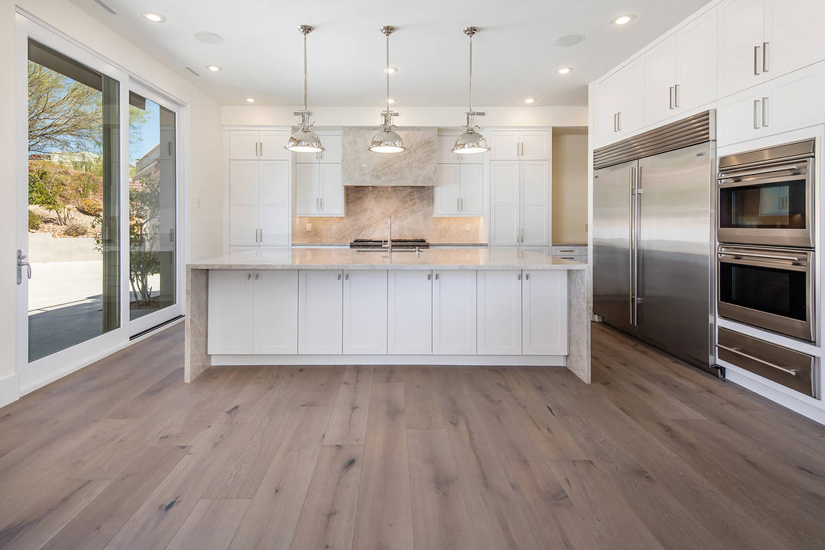 The kitchen features a large island with seating. (Ivan Sher Group)