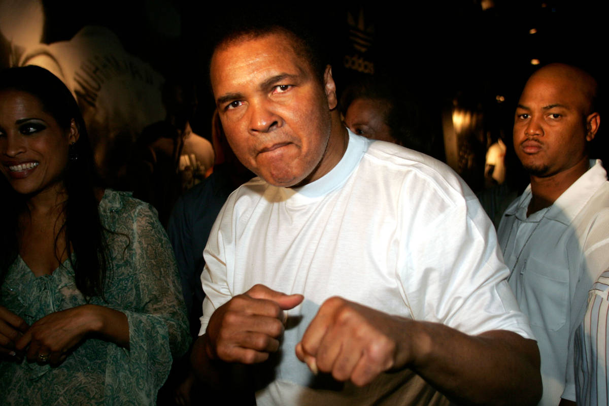 Muhammad Ali shadow boxes for a photographer during an introduction of the new "Ali by adidas" ...