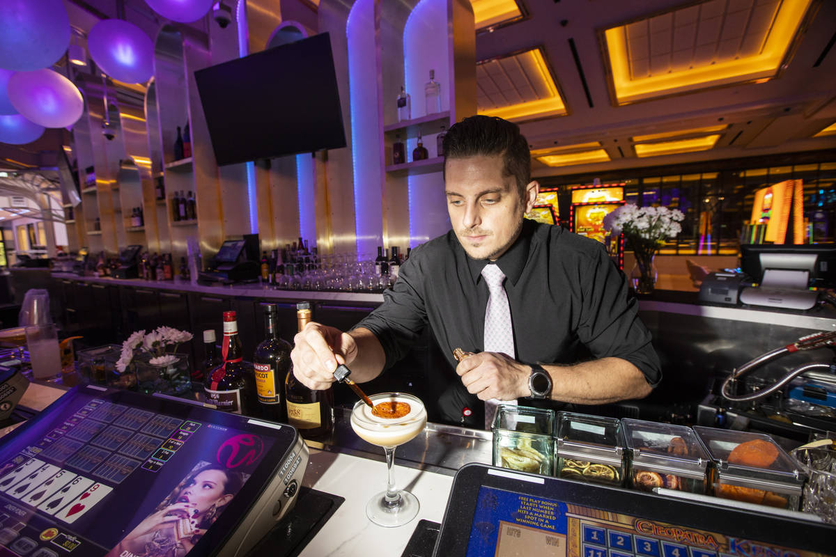 Lead bartender Michael Giambrone prepares the Old Sport cocktail at Gatsby's cocktail lounge du ...